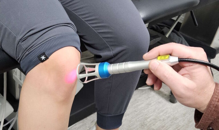 Patient receiving non-invasive Class IV Deep Tissue Laser Therapy to speed up pain relief and healing at Hanson Chiropractic Center in Edmond, OK.