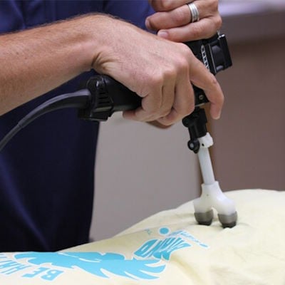 Dr. Ryan Hanson using an Arthrostim for gentle precision chiropractic.