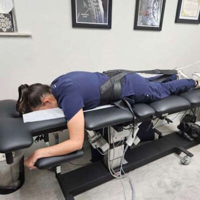 Patient receiving lumbar spinal decompression therapy for sciatica relief at Hanson Chiropractic Center in Edmond.