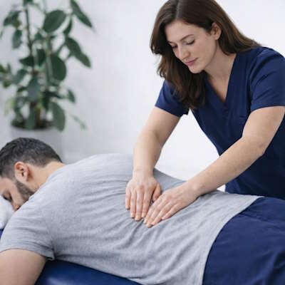 Man receiving a therapeutic table massage from a licensed therapist at Hanson Chiropractic Center in Edmond.